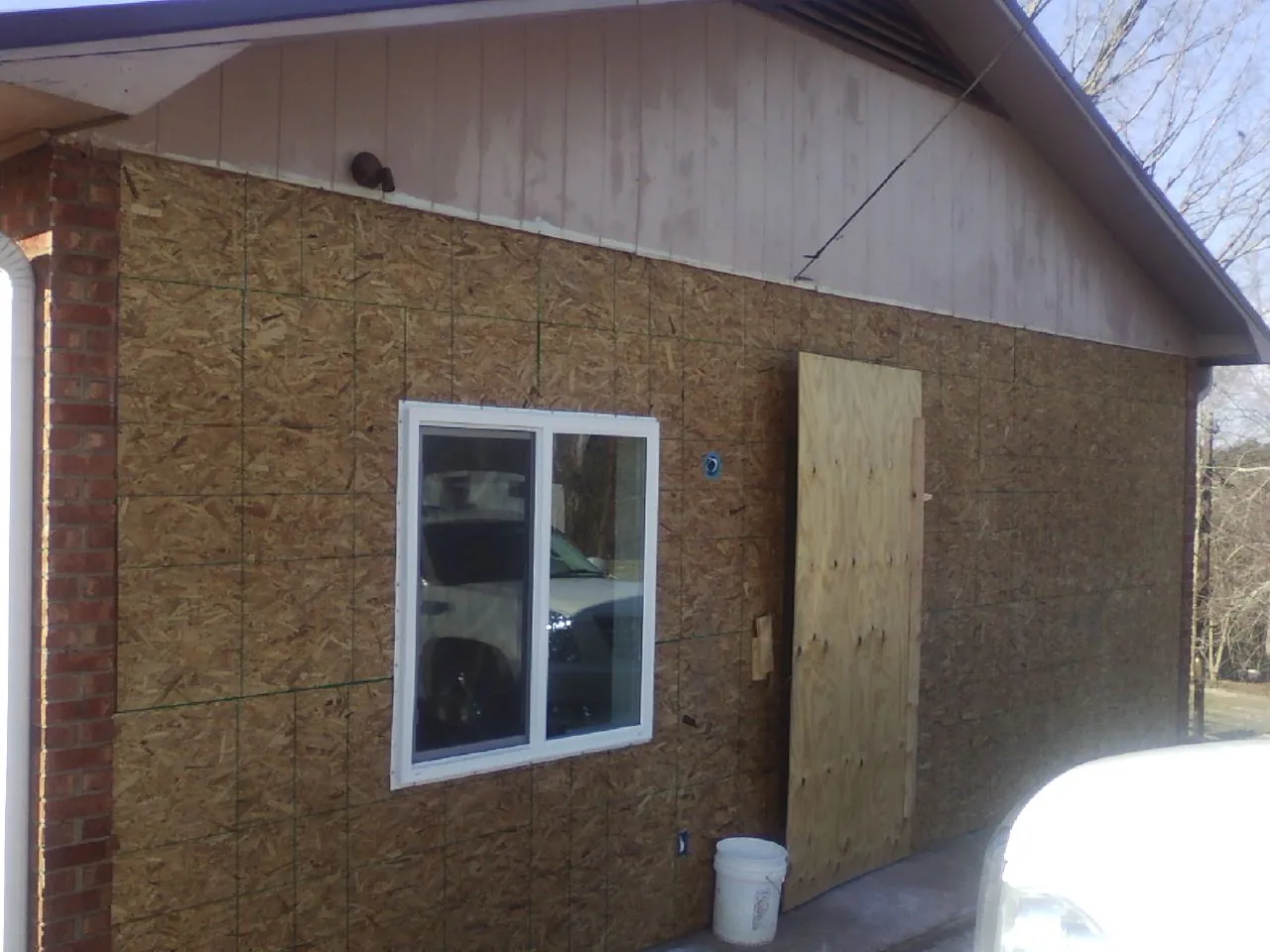 OSB sheathing on a garage addition wall before siding in Orchard Park